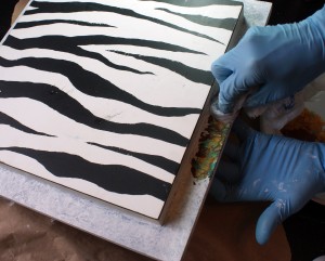 Applying metallic paint to frame with plastic bag