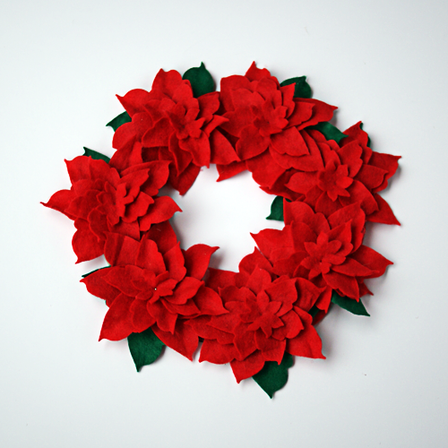 Make a Felt Poinsettia wreath from @DollarTree stocking and cardboard @savedbyloves
