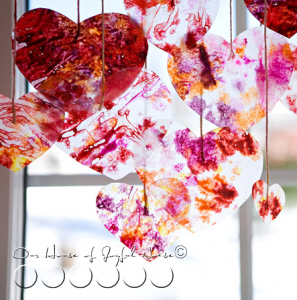 Make crayon hearts for faux stained glass Valentine's Day decor via House of Joyful Noise, featured @savedbyloves