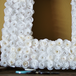 Make a cupcake liner rosette frame with #DIY from @savedbyloves