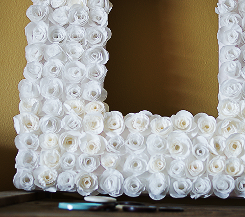 Make a cupcake liner rosette frame with #DIY from @savedbyloves